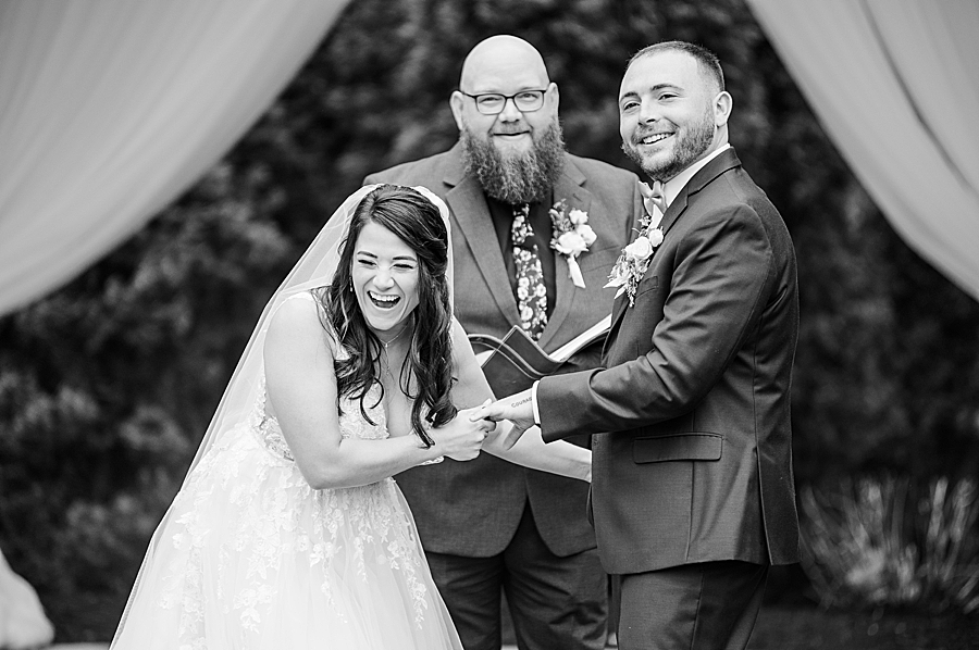 Bride and groom laughing at Wedding by Amanda May Photos