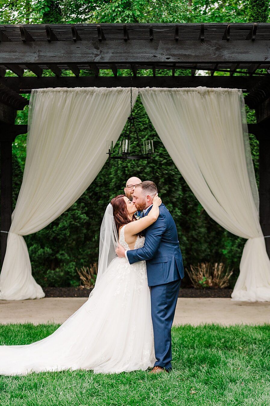 Bride and groom share kiss at Wedding by Amanda May Photos