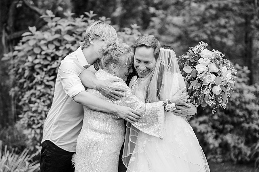 Family hugging at Wedding by Amanda May Photos