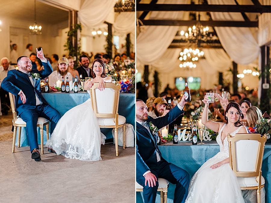 Couple and guests raise glasses at Wedding by Amanda May Photos