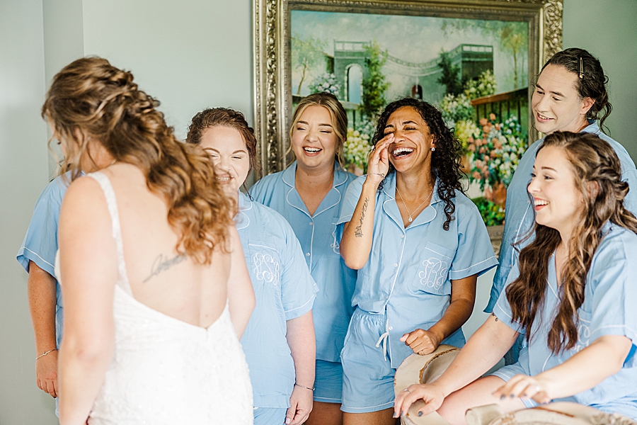 Bridesmaids laughing at Castleton Farms Wedding with a Rainbow by Amanda May Photos