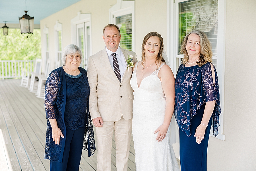Family smiling at camera during Castleton Farms Wedding with a Rainbow by Amanda May Photos