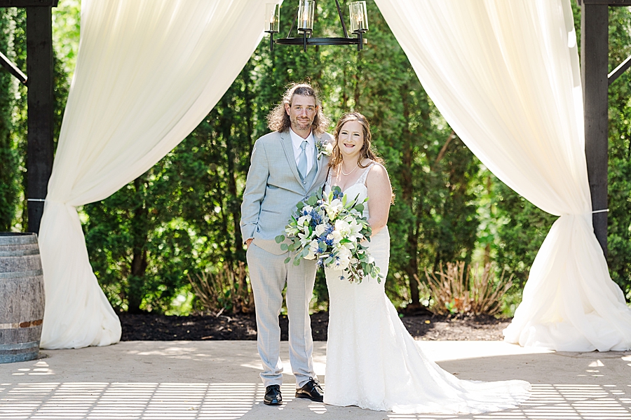 Smiling at Castleton Farms Wedding with a Rainbow by Amanda May Photos