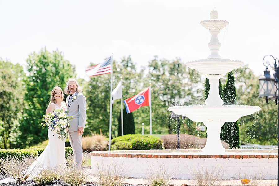 Standing by Fountain at Castleton Farms Wedding with a Rainbow by Amanda May Photos
