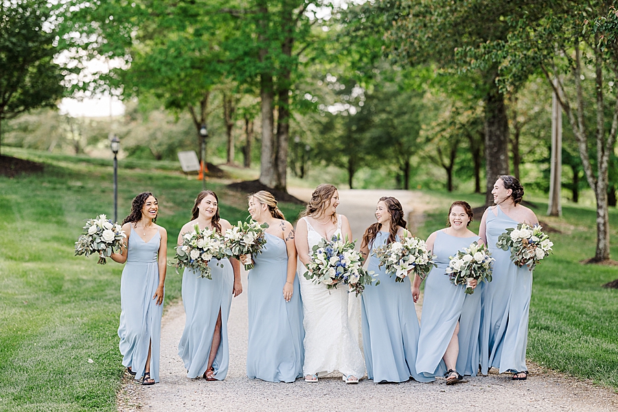 Bride and bridesmaids laughing at Castleton Farms Wedding with a Rainbow by Amanda May Photos