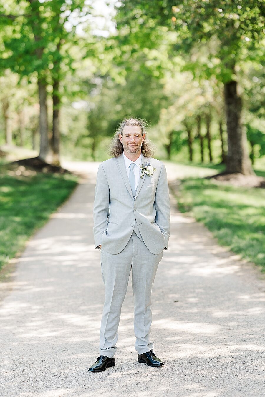 Groom smiling at Castleton Farms Wedding with a Rainbow by Amanda May Photos