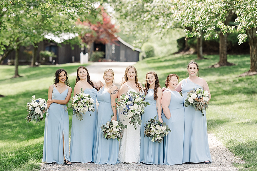 Bride and bridesmaids smile at Castleton Farms Wedding with a Rainbow by Amanda May Photos