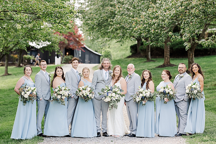 Wedding party smiling at Castleton Farms Wedding with a Rainbow by Amanda May Photos