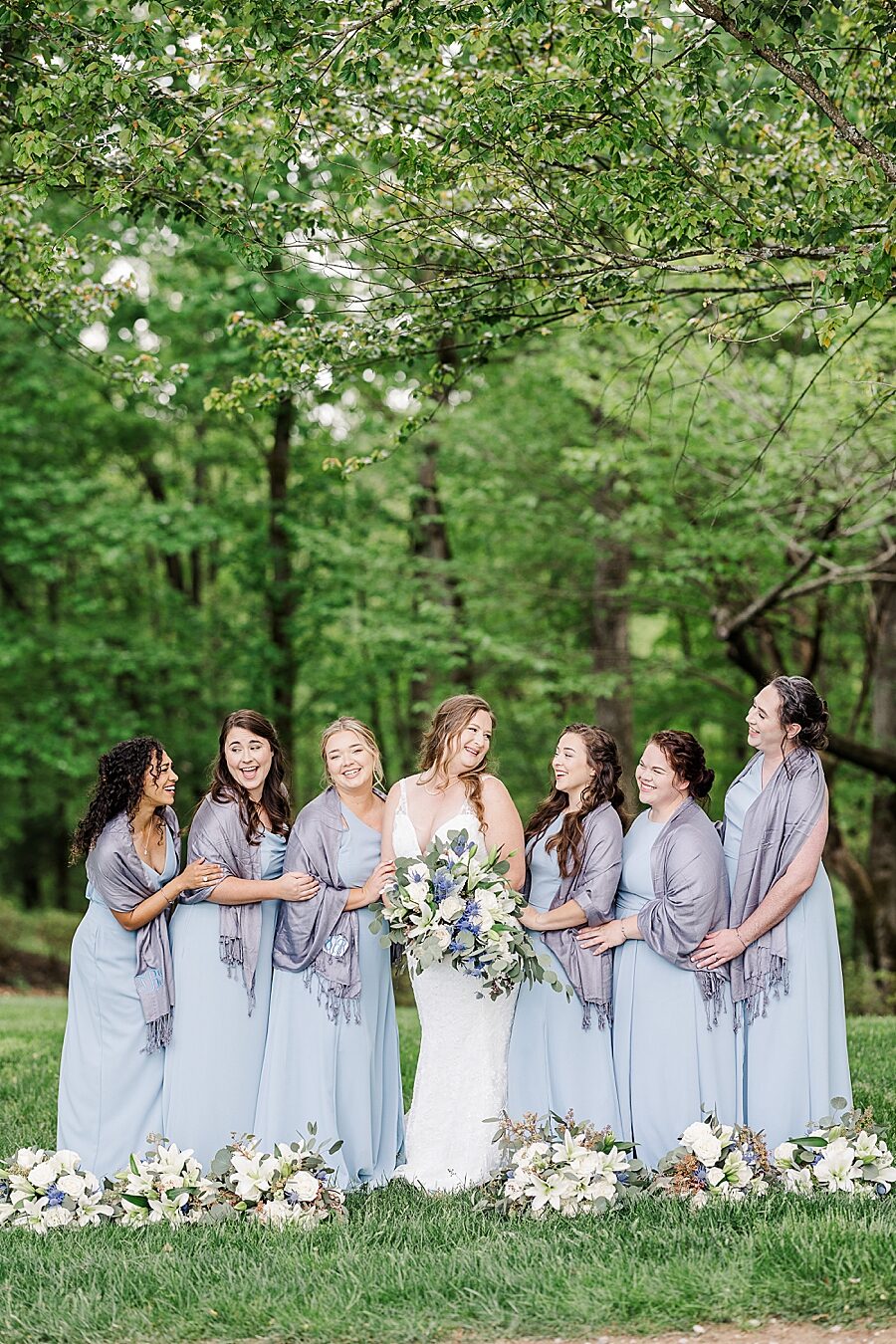 Bride laughing with bridesmaids at Castleton Farms Wedding with a Rainbow by Amanda May Photos