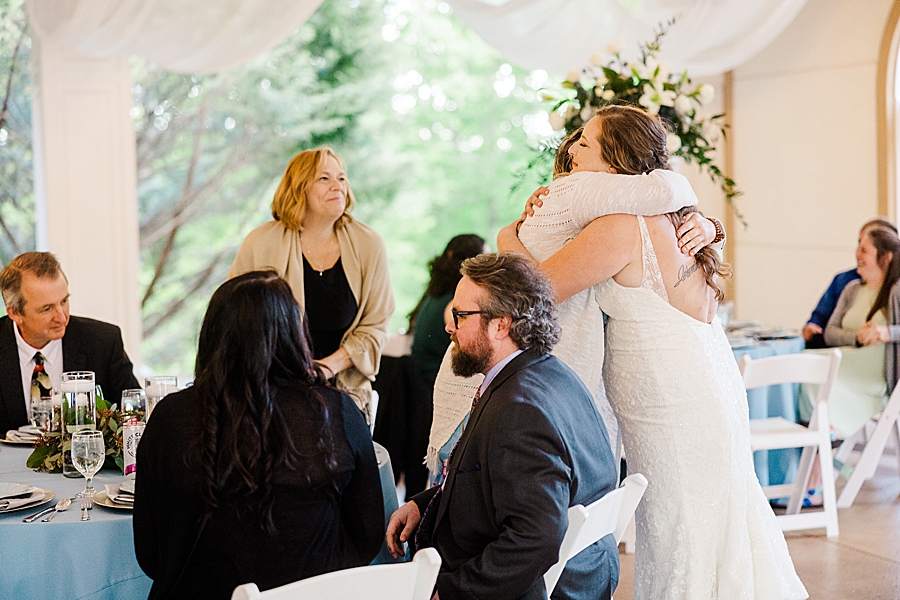 Hugging guests at Castleton Farms Wedding by Amanda May Photos