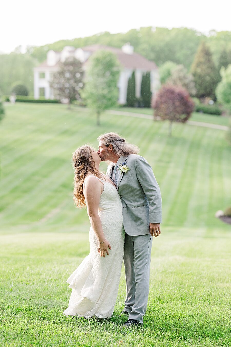 Kissing at Castleton Farms Wedding by Amanda May Photos