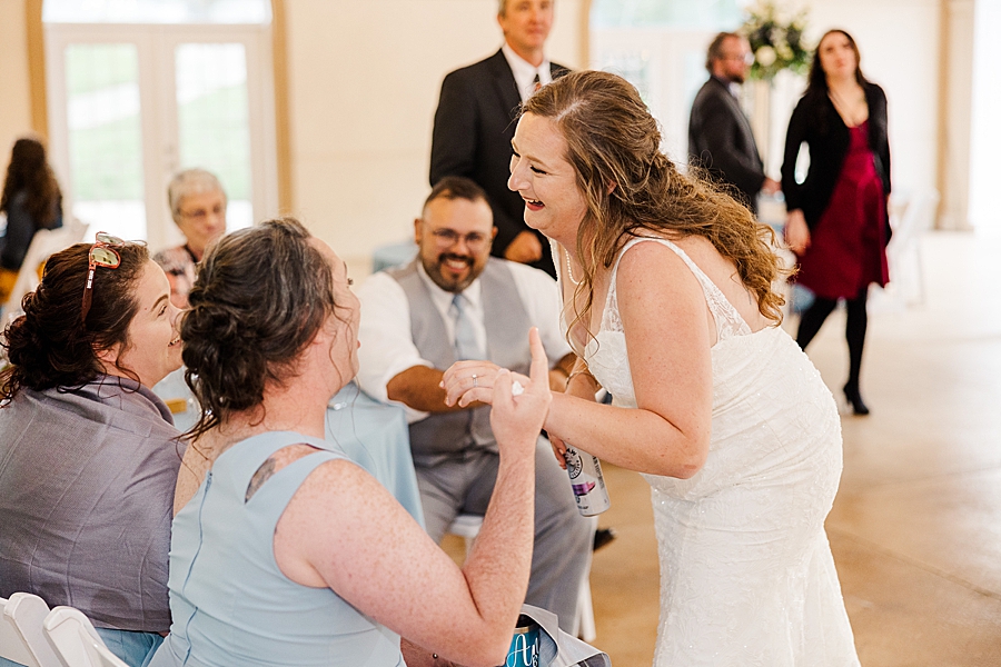 Laughing with guests at Castleton Farms Wedding by Amanda May Photos