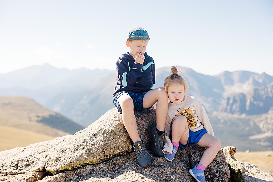Brother and sister sitting on a rock in the Rocky Mountain National Park by Knoxville Wedding Photographer, Amanda May Photos.