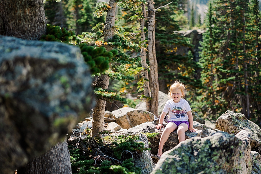 Sitting on a stack of rocks at Lake Haiyaha in the Rocky Mountain National Park by Knoxville Wedding Photographer, Amanda May Photos.