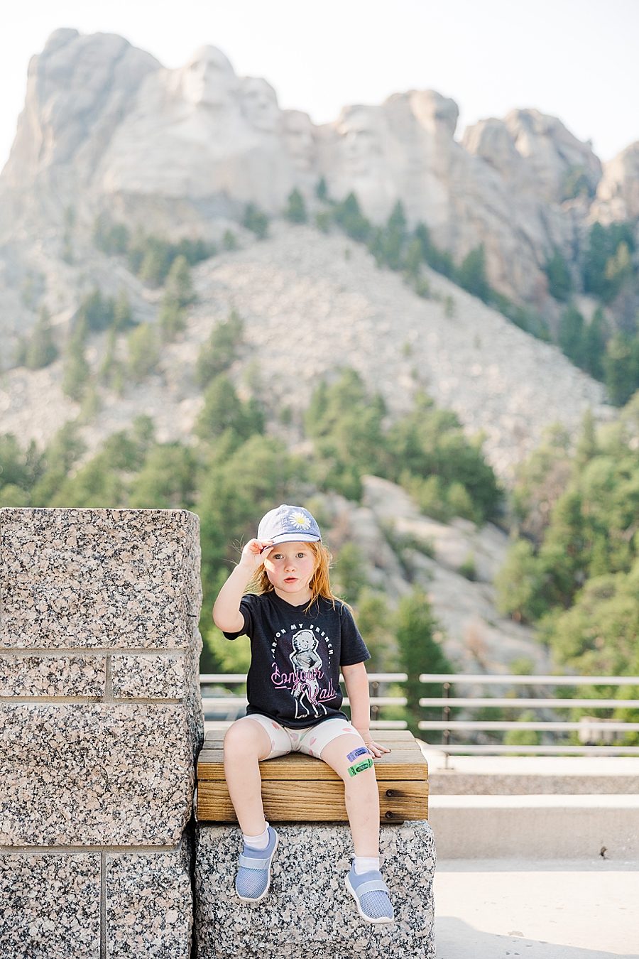Holding her hat at Mount Rushmore by Knoxville Wedding Photographer, Amanda May Photos.