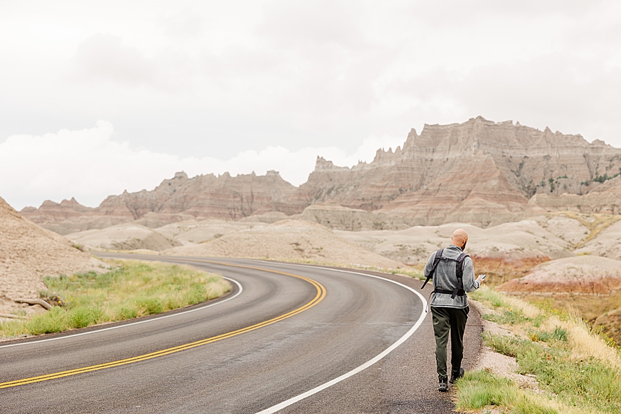 Dad and baby walking on road at Badlands National Park in South Dakota by Knoxville Wedding Photographer, Amanda May Photos.