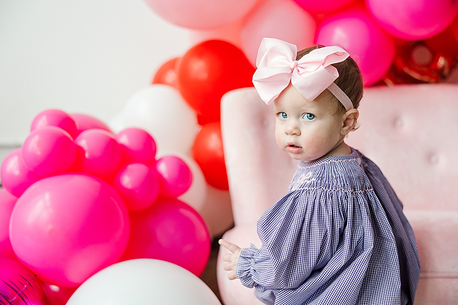 baby in large pink bow