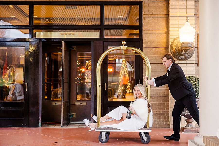 riding a luggage cart
