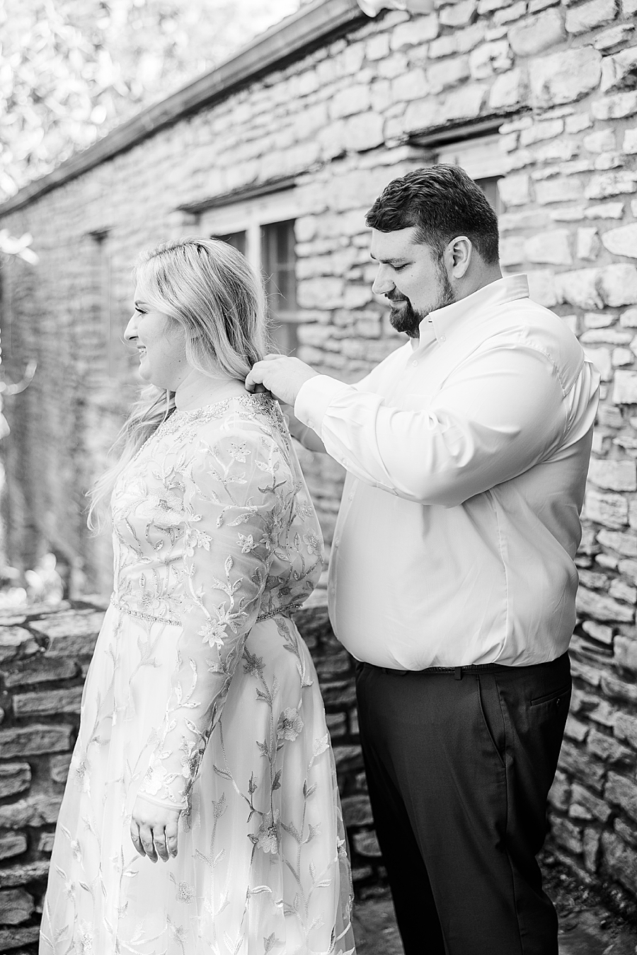 Groom zipping bride's dress at Knoxville Botanical Gardens Wedding by Amanda May Photos