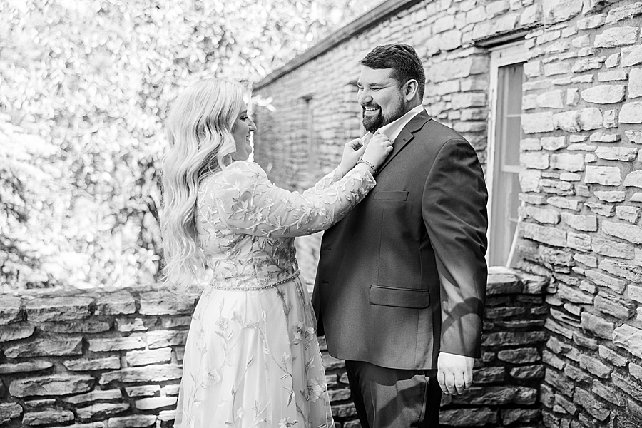 Bride helping groom get ready at Knoxville Botanical Gardens Wedding by Amanda May Photos