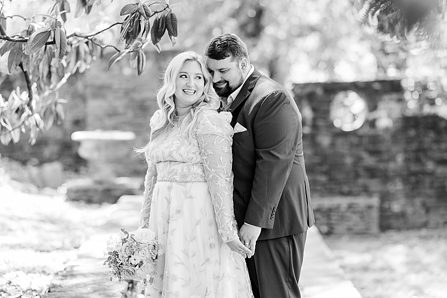 Groom whispering in bride's ear at Knoxville Botanical Gardens Wedding by Amanda May Photos