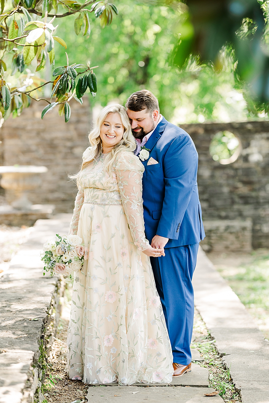 Groom hugs bride from behind at Knoxville Botanical Gardens Wedding by Amanda May Photos