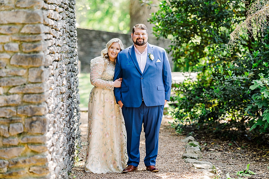 Bride holds groom's arm at Knoxville Botanical Gardens Wedding by Amanda May Photos