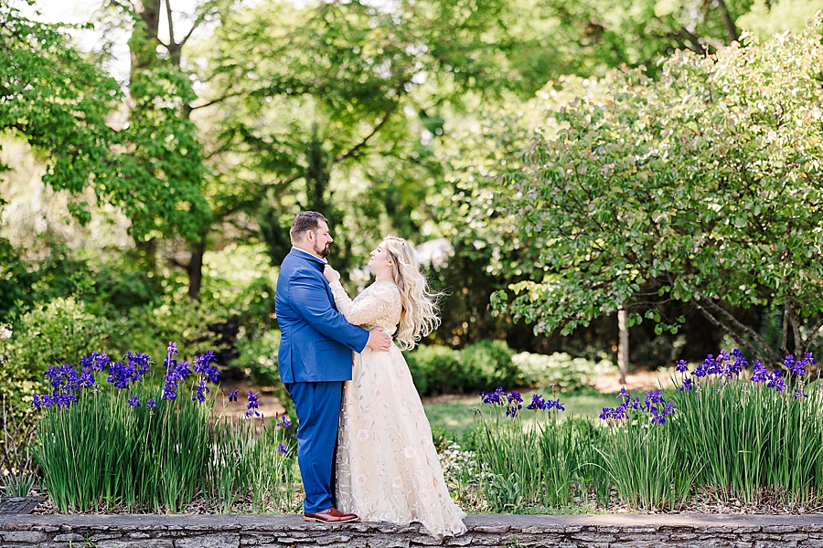 Hugging in front of the flowers at Knoxville Botanical Gardens Wedding by Amanda May Photos