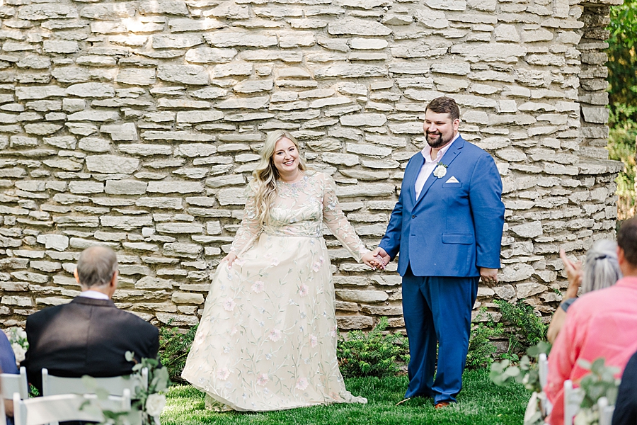 Turning towards the guests at Knoxville Botanical Gardens Wedding by Amanda May Photos