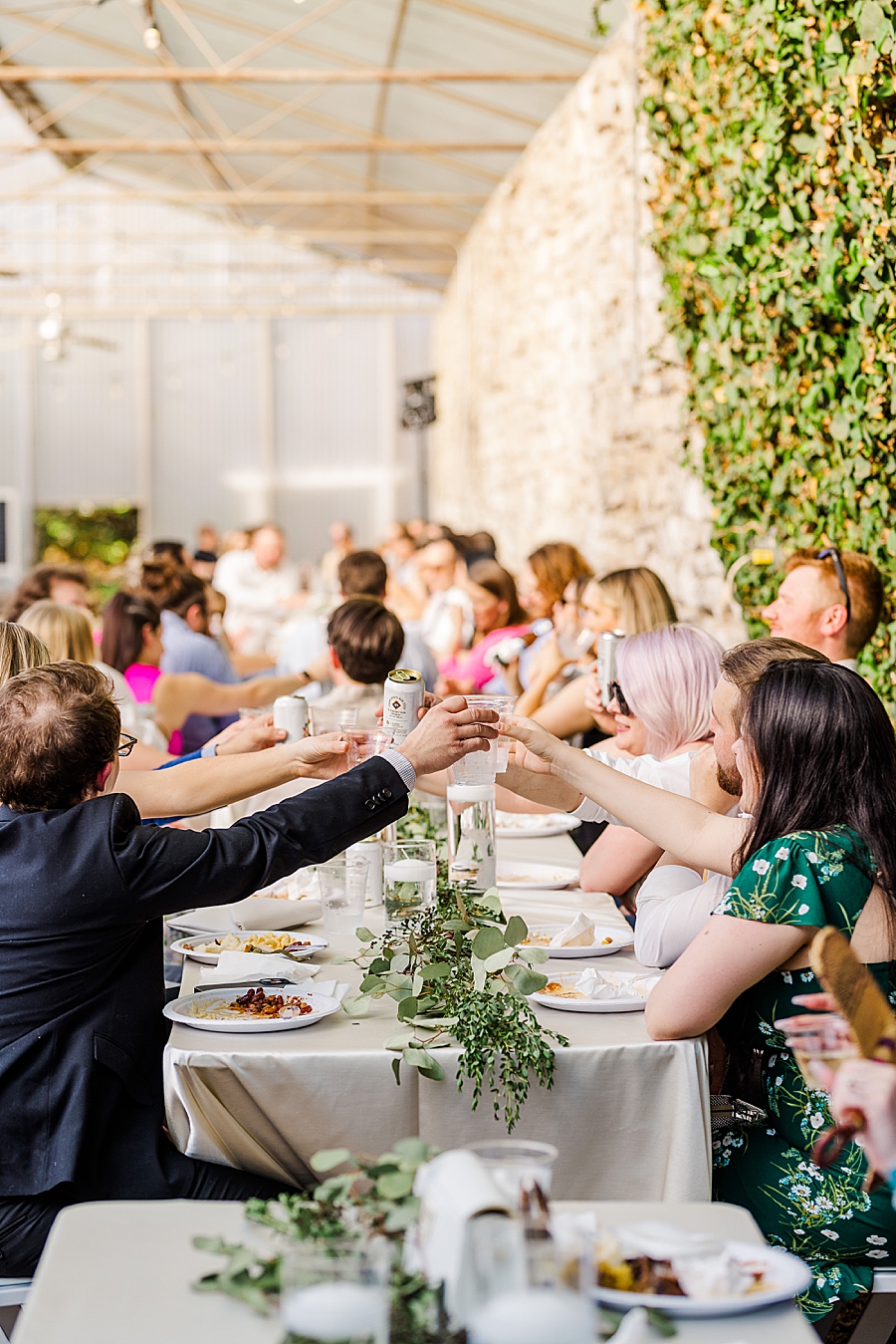 Guests raise glasses at Wedding by Amanda May Photos