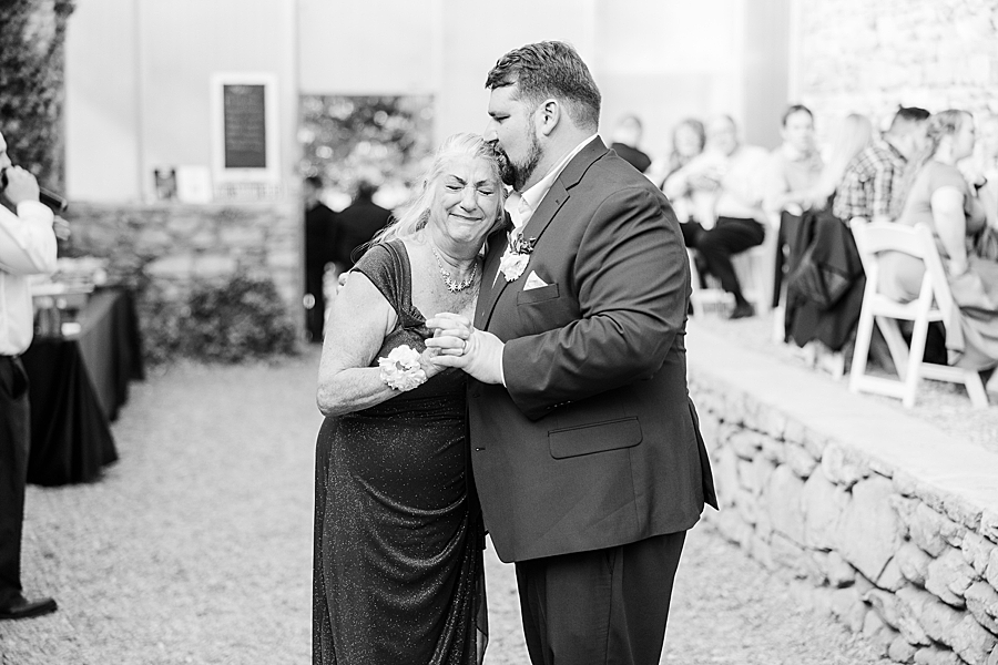 Groom and mom hug at Wedding by Amanda May Photos