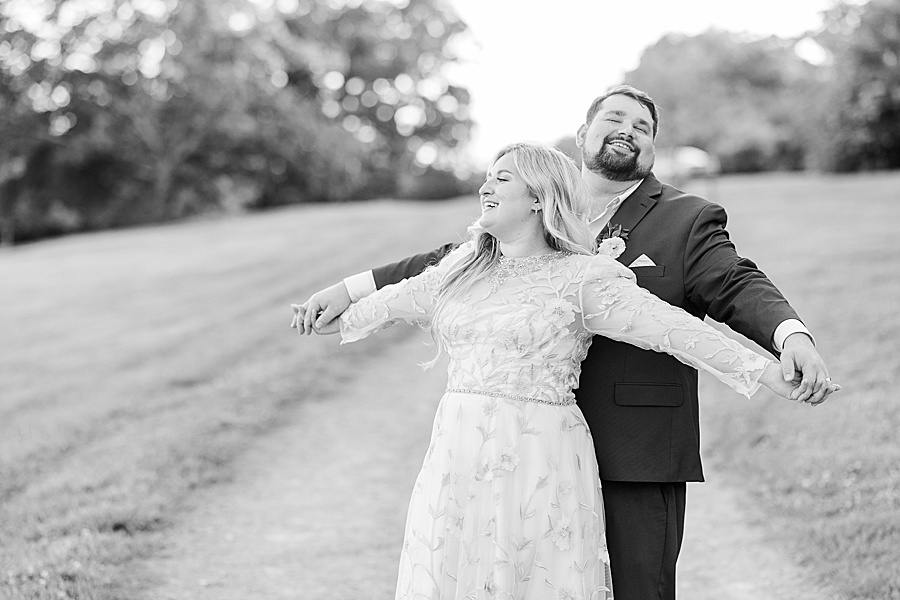 Hugging her from behind at Wedding by Amanda May Photos