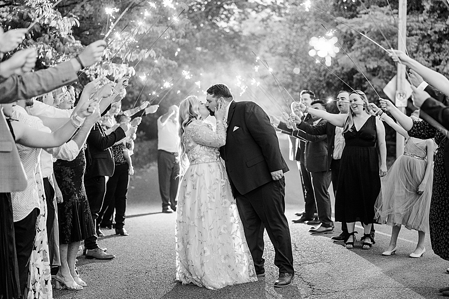 Kissing under sparklers at Wedding by Amanda May Photos