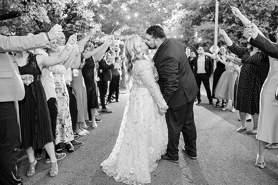 Kissing under sparklers at Wedding by Amanda May Photos