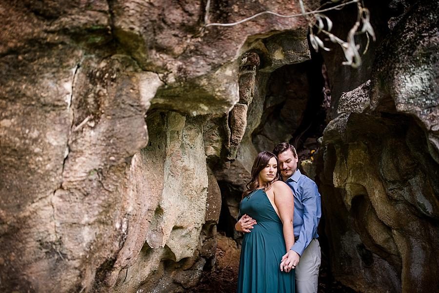 Standing in a cave at this Knoxville engagement session at The Quarry by Knoxville Wedding Photographer, Amanda May Photos.