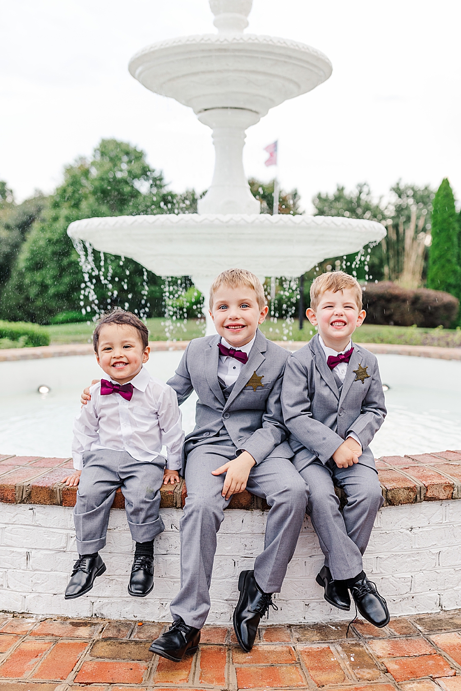 boys sitting on fountain