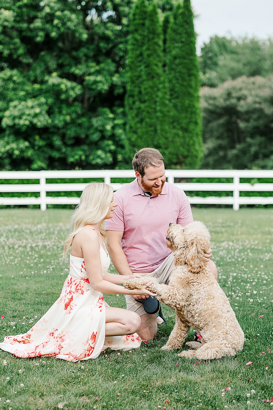 couple playing with labradoodle at castleton engagement