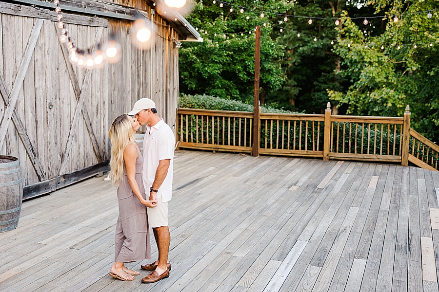 kissing on a rustic deck