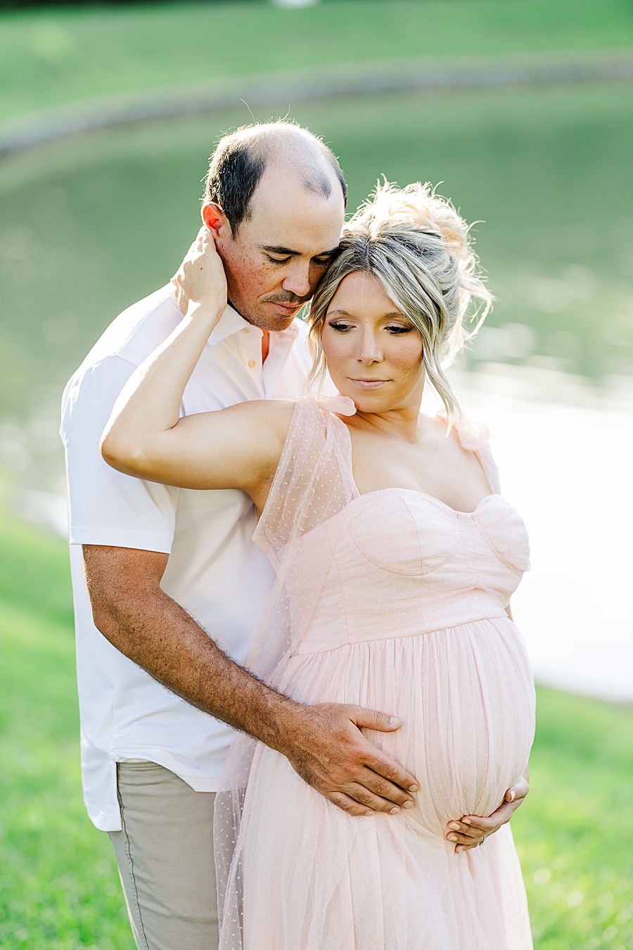 couple by pond at castleton farms maternity session