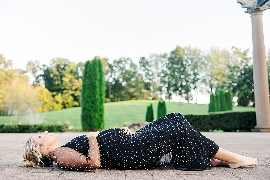 woman in black dress at castleton farms maternity session