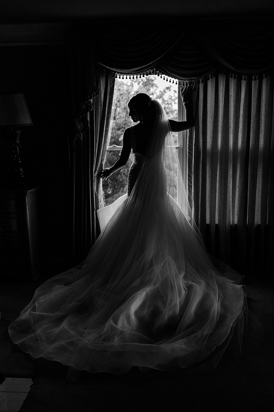 bride standing in window at castleton wedding