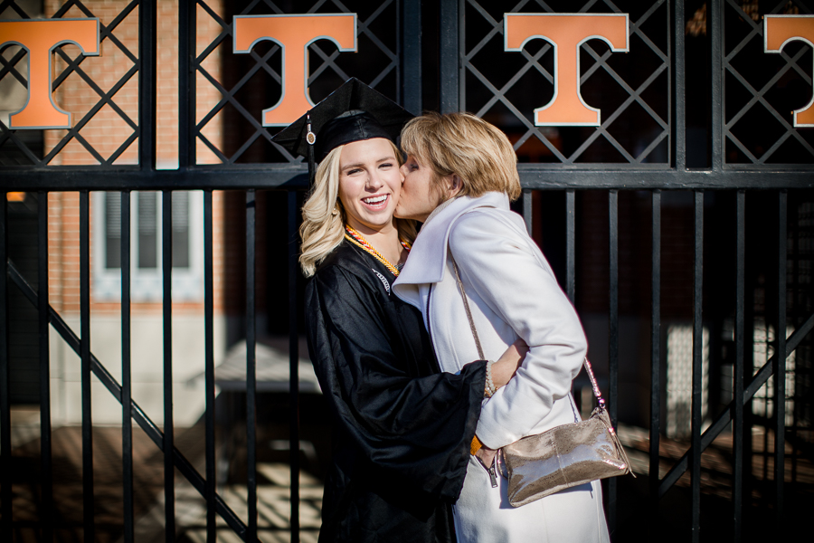 Mom kissing her cheek at this University of Tennessee graduation by Amanda May Photos.
