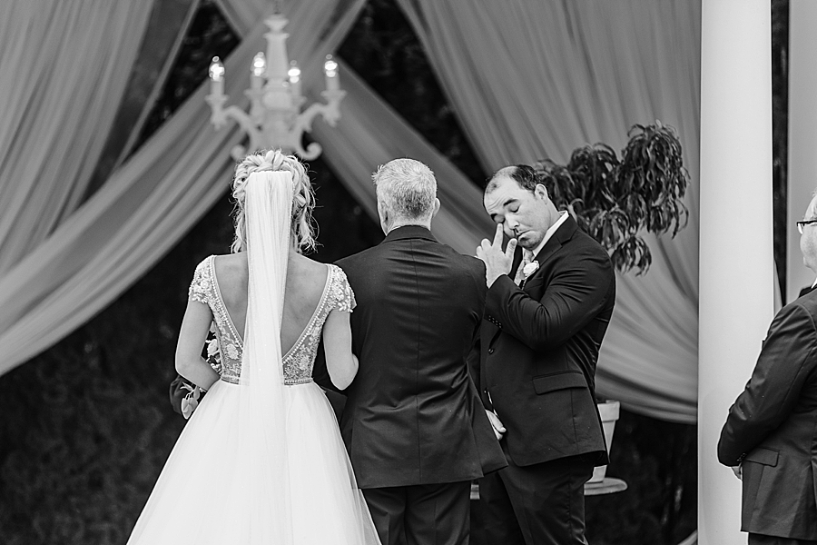 groom wiping tear at cinderella wedding