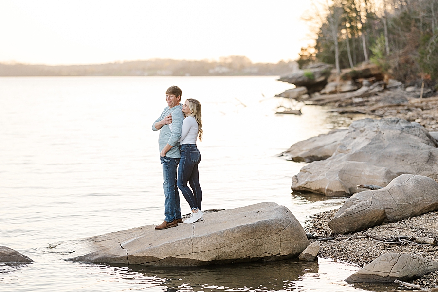 couple standing on boulder by tennessee river
