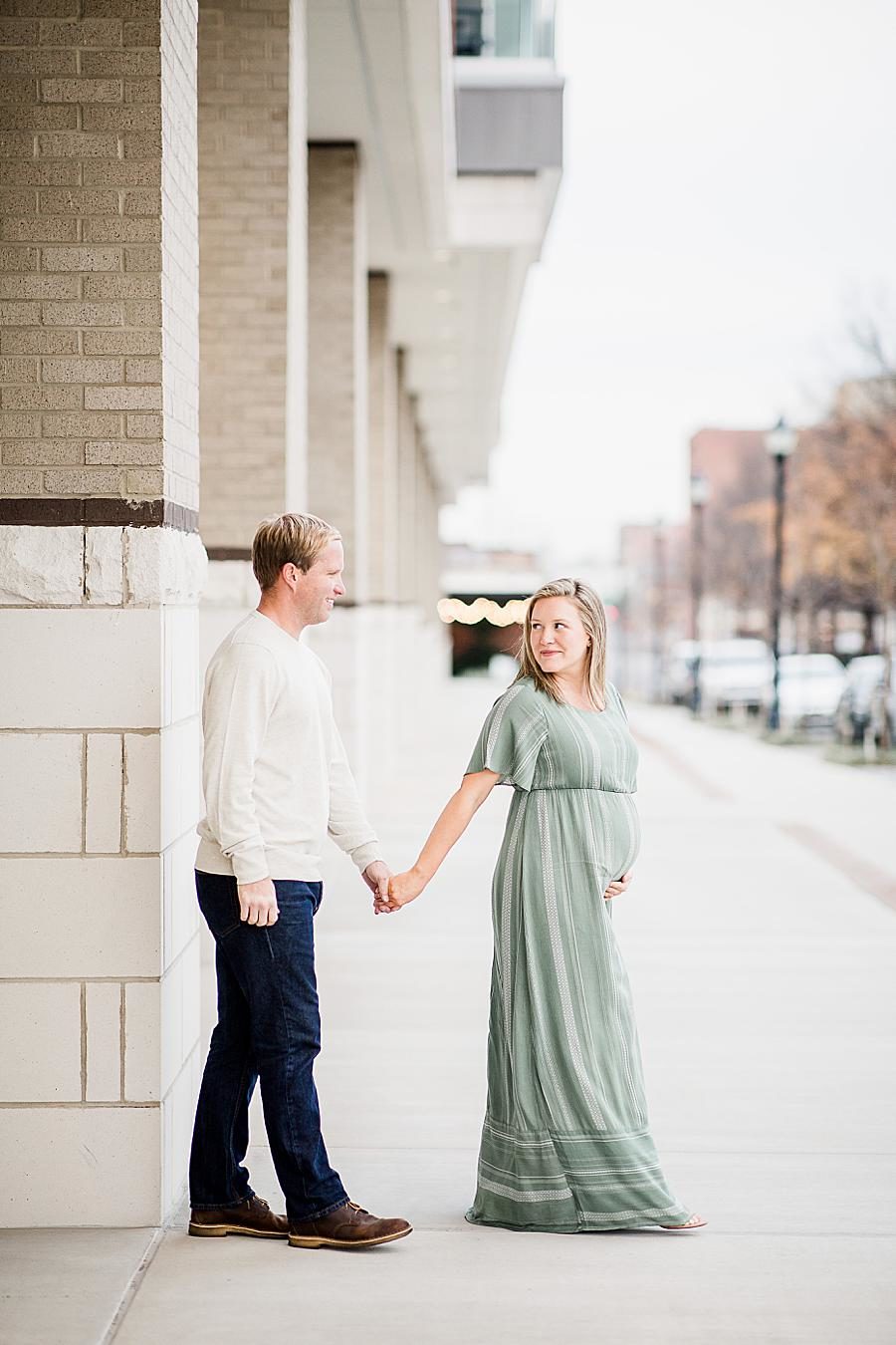 Holding hands at this Downtown Knoxville Maternity by Knoxville Wedding Photographer, Amanda May Photos.