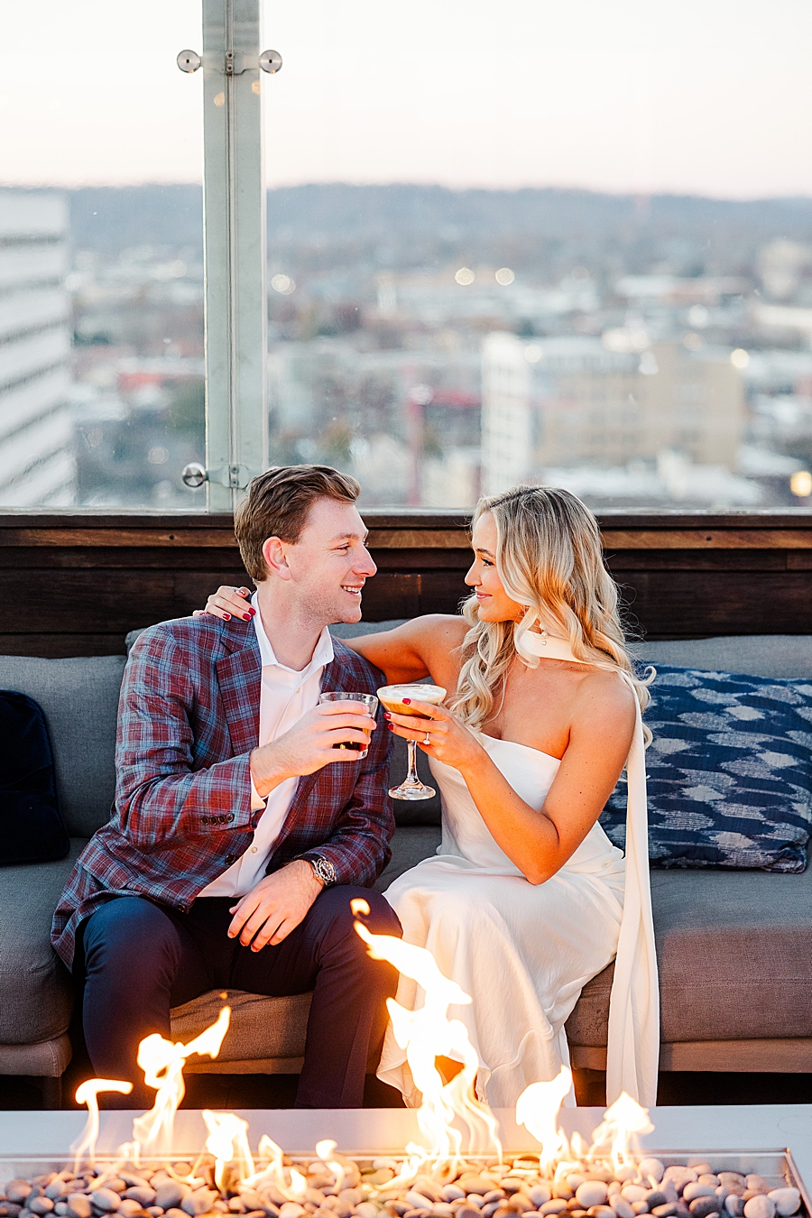 couple drinking cocktails by fire pit