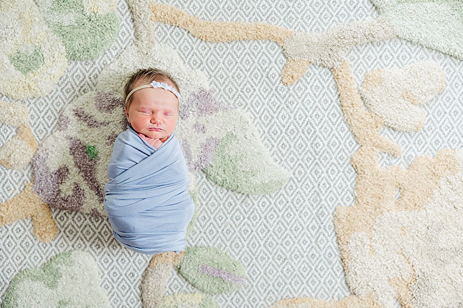 baby girl on colorful rug