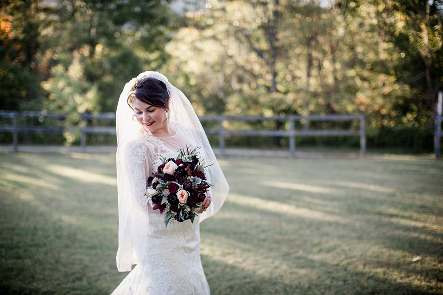 Walking and looking back down over her shoulder at this bridal session at The Barn at High Point Farms by Knoxville Wedding Photographer, Amanda May Photos.
