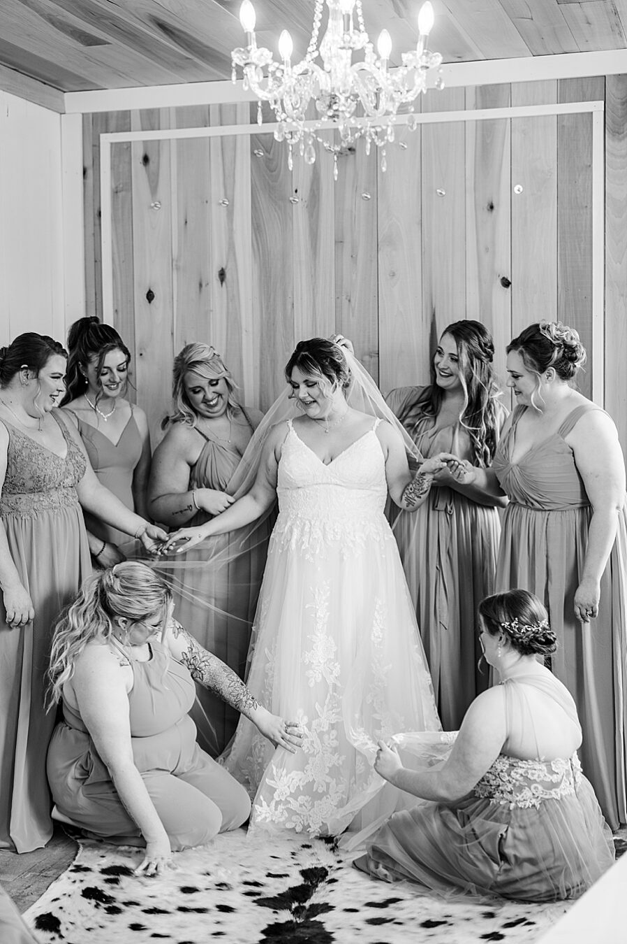 Bridesmaids help bride get ready at Allenbrooke Farm wedding by Amanda May Photos