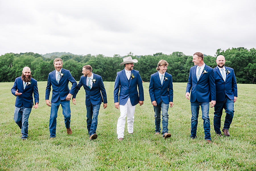 Groom walking with groomsmen at Allenbrooke Farm wedding by Amanda May Photos